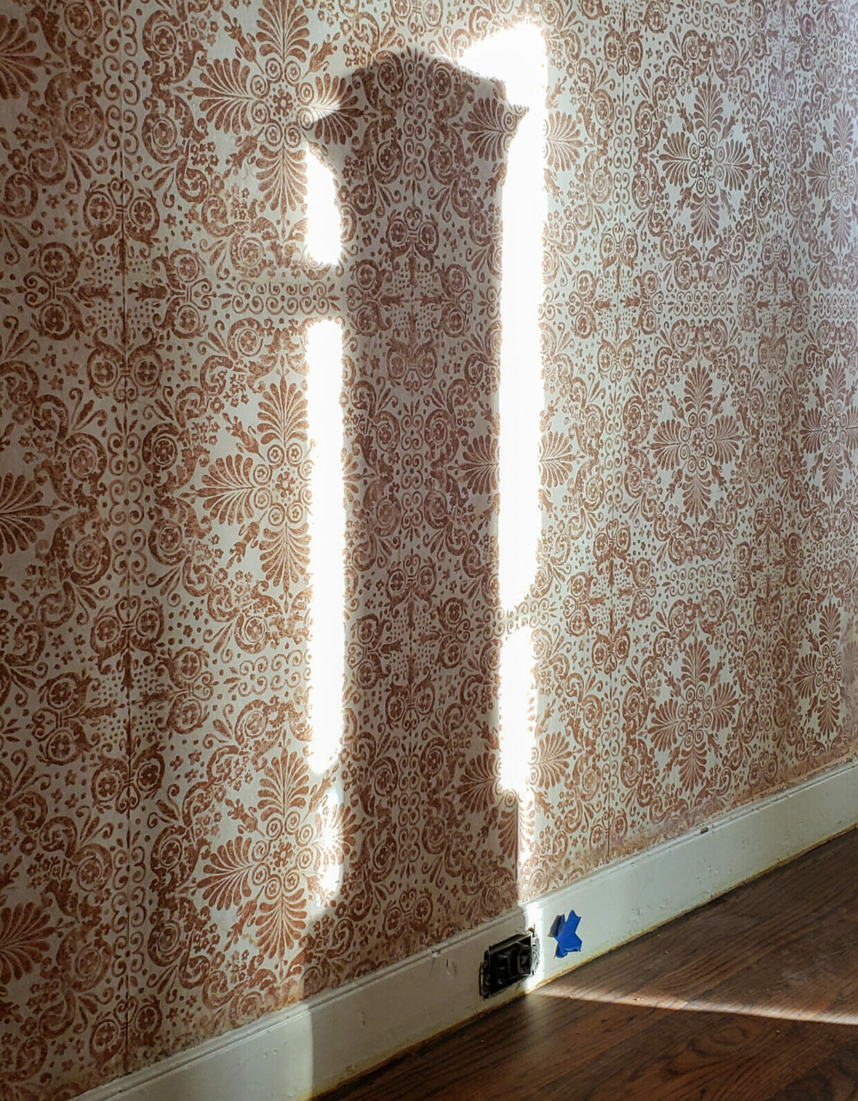 Shadow of a newel post on 1920s wallpaper